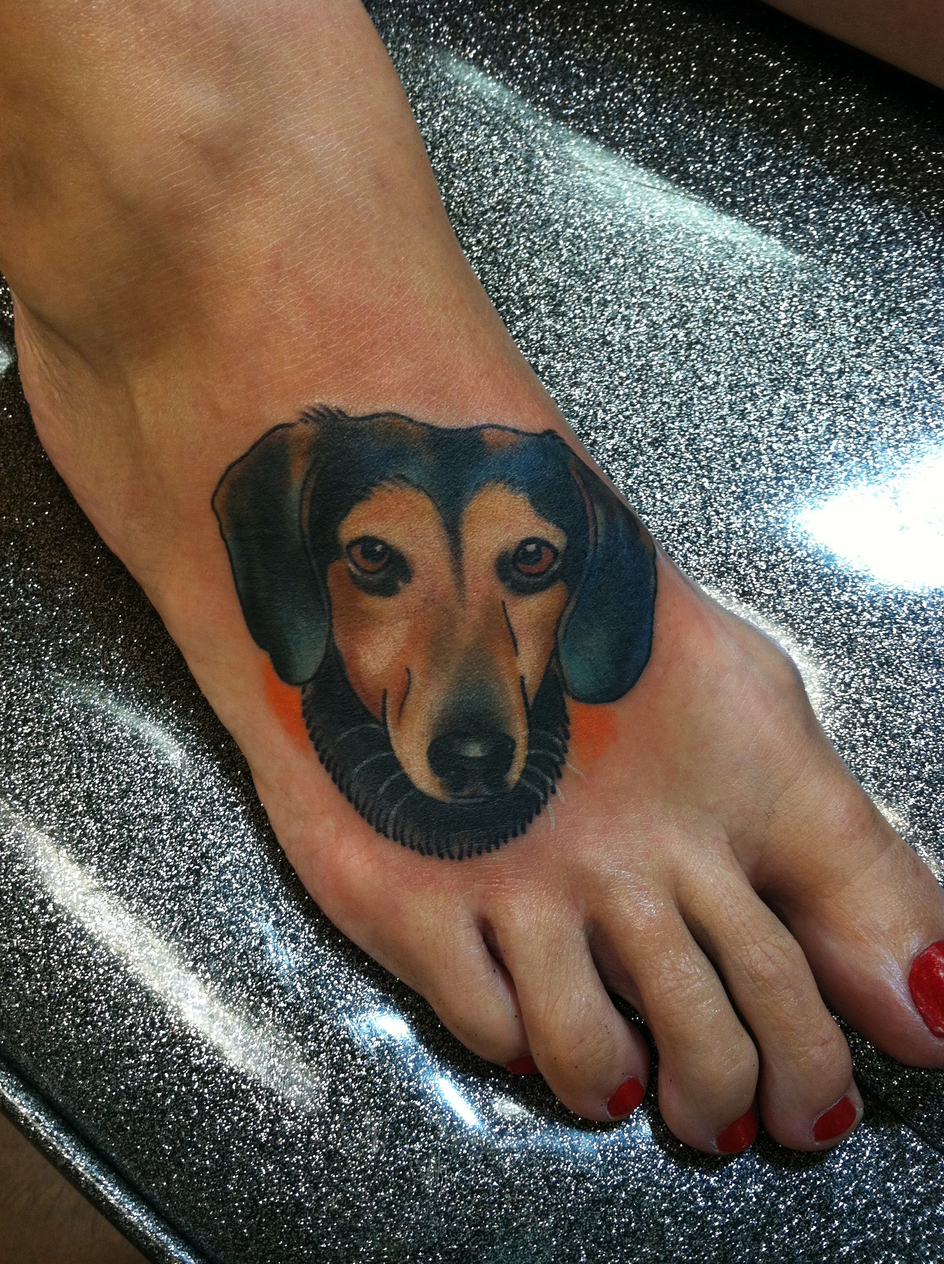 custom color dog portrait foot tattoo by david meek of fast lane tattoo in tucson arizon with kingpin tattoo supply