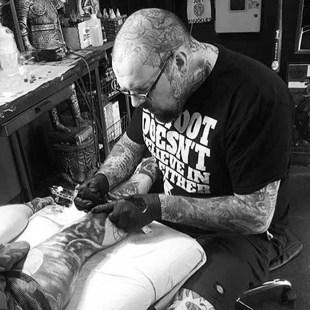 Joey Knuckles tattooing in Columbus Ohio at Sacred Hand Tattoo Society