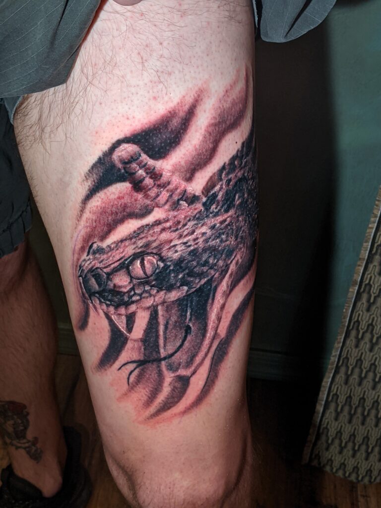 Black and Grey Realistic Diamondback Rattlesnake Leg Tattoo by David Meek of Art and Sol Tattoo in Tucson Arizona